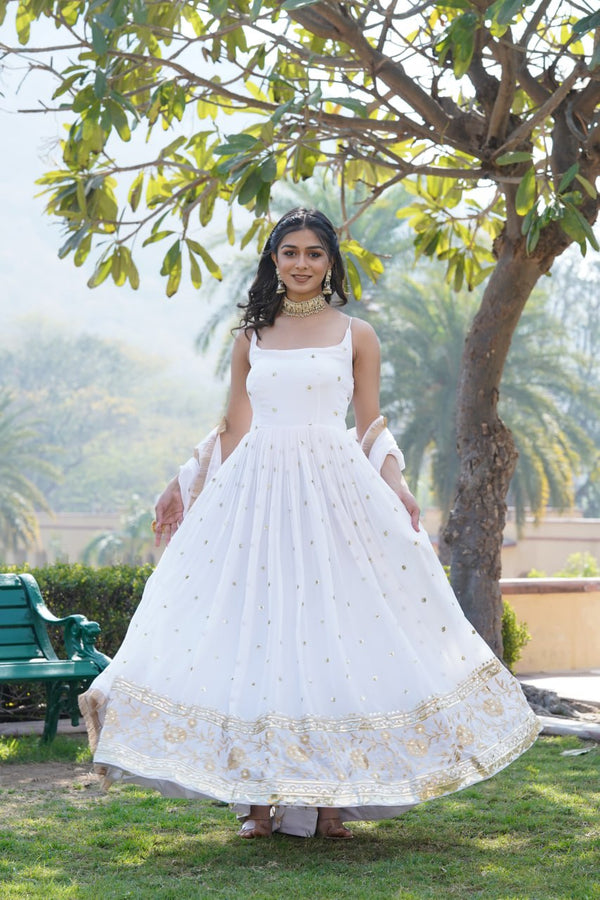 Exquisite floor-length gown adorned with intricate lace and delicate beadwork.